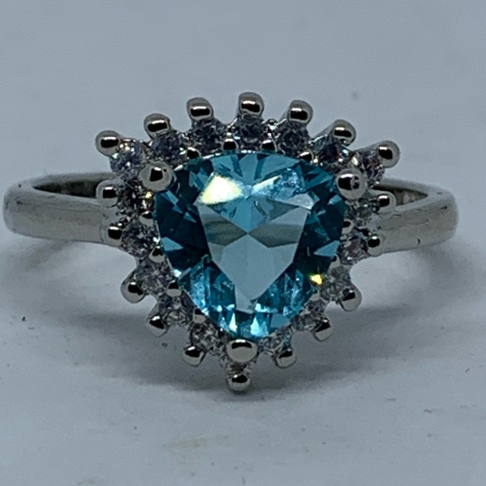 Blue topaz triangle surrounded by white topaz